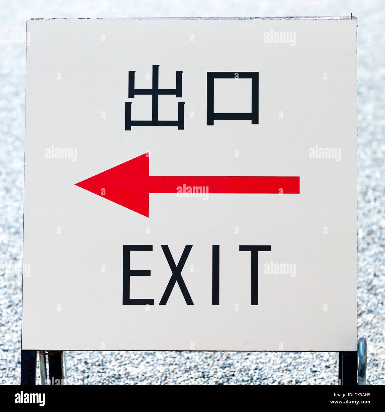 Schild mit einem roten Pfeil nach links und das Wort EXIT in englischer Sprache und in japanischen Kanji-Schrift die Symbole für beenden und Mund Stockfoto