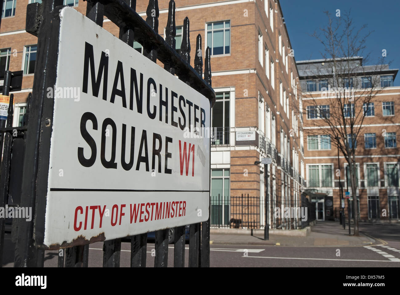 Straßenname Zeichen für Manchester Square, London, England, mit Emi Records Gebäude im Hintergrund Stockfoto
