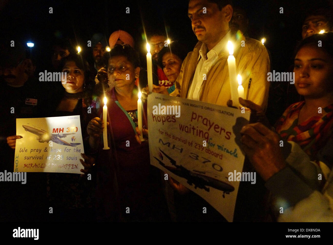 Amritsar, Indien 20. März 2014: Mitglieder der Akhil Bharatiya Menschenrechtsorganisation mit einer Kerze Licht Mahnwache für die Sicherheit der Passagiere des fehlenden malaysischen Ebene in Amritsar am Donnerstag. Das fehlende Flugzeug verschwand die 227 Passagiere und 12 Mannschaft, verblüffende internationale Rettungs- und Suchaktionen Teams, die keine Überreste gefunden haben vor einer Woche oder Hinweise in den Gewässern um Süd-Ost-Asien. Alle Passagiere und Besatzungsmitglieder sind derzeit in Untersuchung für mögliche Sabotage, obwohl keine Beweise für solche Aktivität gefunden wurde. (Foto von Prabhjot Gill/Pacific Press) Stockfoto