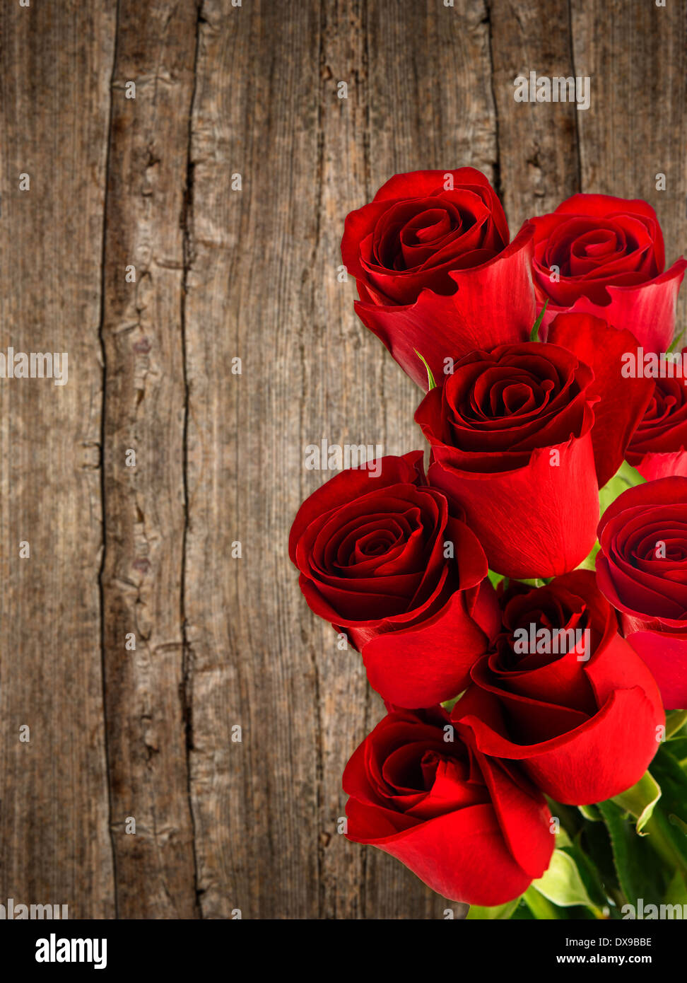 Bouquet von frischen roten Rosenblüten über rustikale Holz Hintergrund Stockfoto