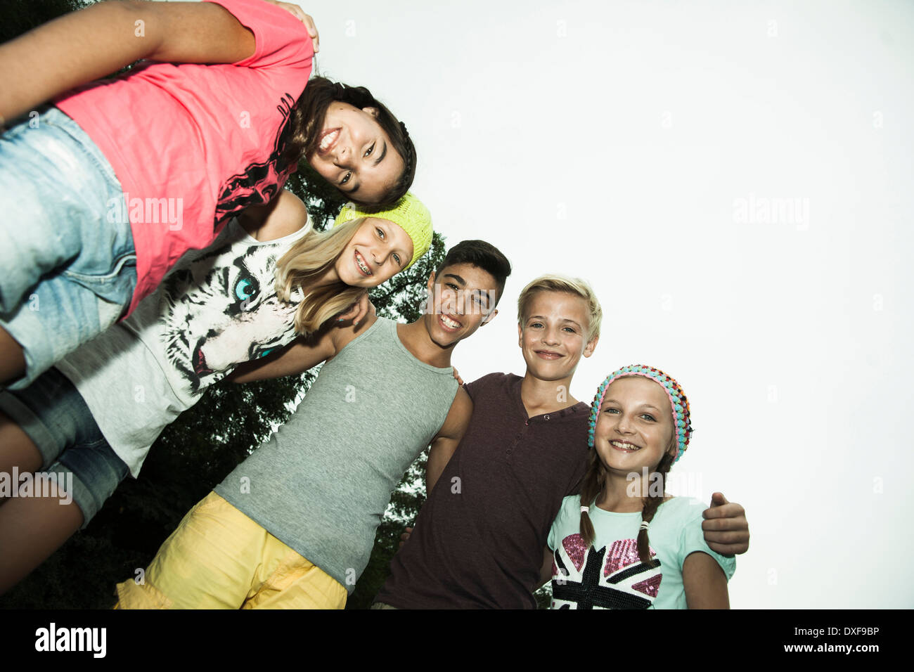 Gruppe von Kindern zusammen mit Arme Erde andere, stehend schaut und lächelt in die Kamera, Deutschland Stockfoto