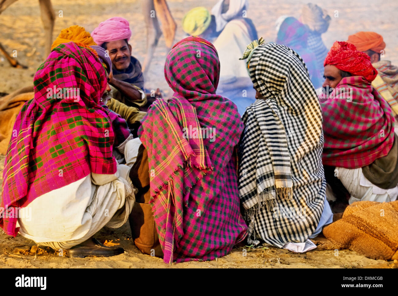 Indische Männer sitzen am Lagerfeuer bei Pushkar Camel fair, Indien Stockfoto
