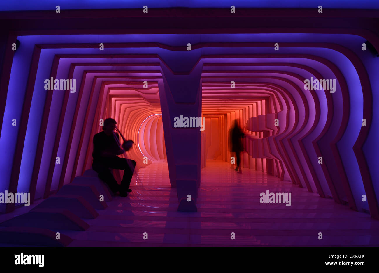 Blechbläser Uwe Dierksen (L) das "Ensemble Modern" spielt auf einer Trompete als Teil der Licht- und Tontechnik Installation "Hornhaut TI' von Innenarchitektur-Studenten der Universität Mainz, während der Luminale 2014 in Frankfurt am Main, 29. März 2014. Mehr als 182 Lichtinstallation sind ausgestattet mit künstlerischen Spektakel des Lichts bei der 7. Auflage des Biennals Arts Festival der Lichter Kultur in Frankfurt. Foto: Arne Dedert/dpa Stockfoto