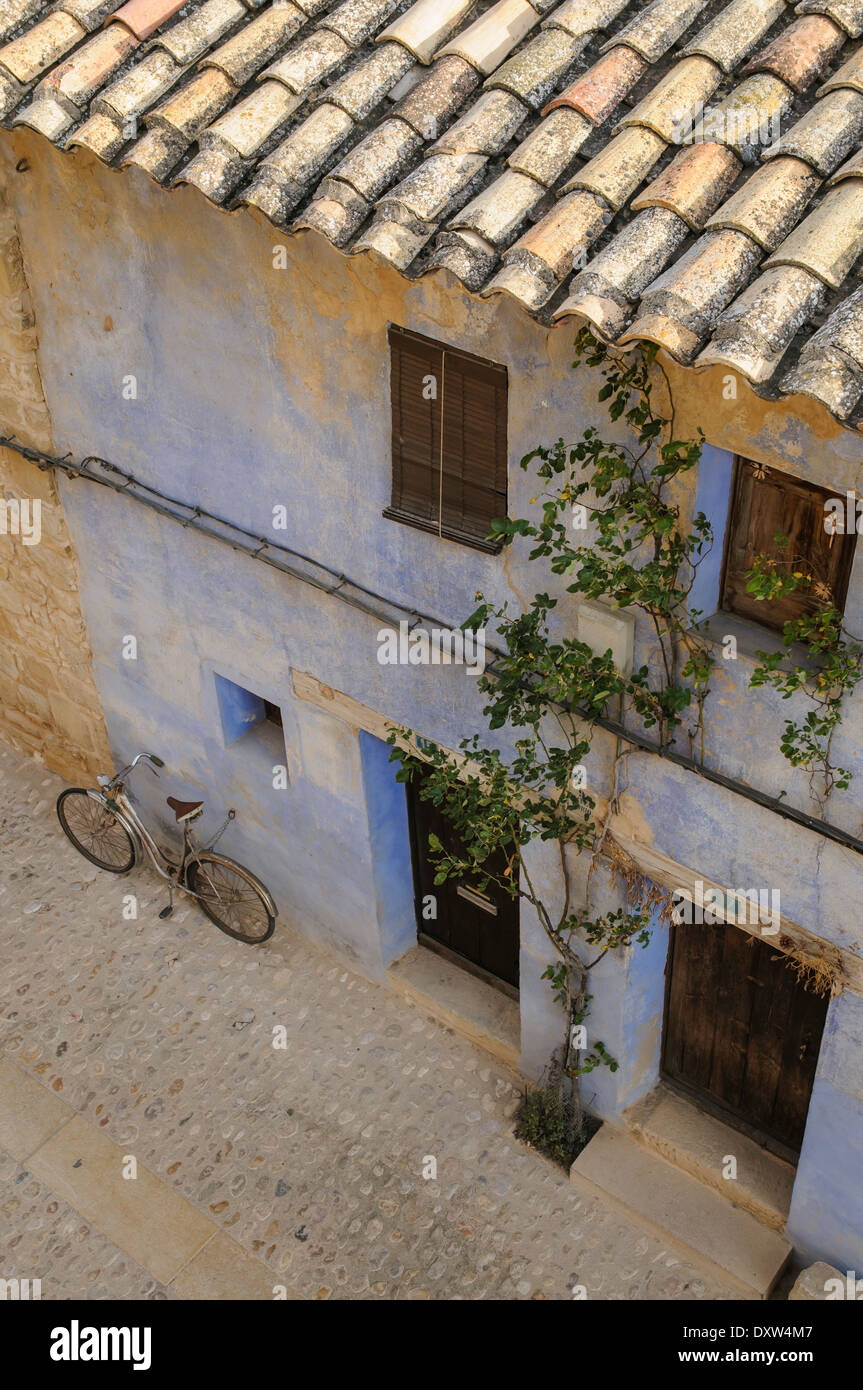 Fahrrad und blau lackierten Traditionshaus für Ferien auf gepflasterte Straße im alten Bereich, Valderrorres, Spanien Stockfoto