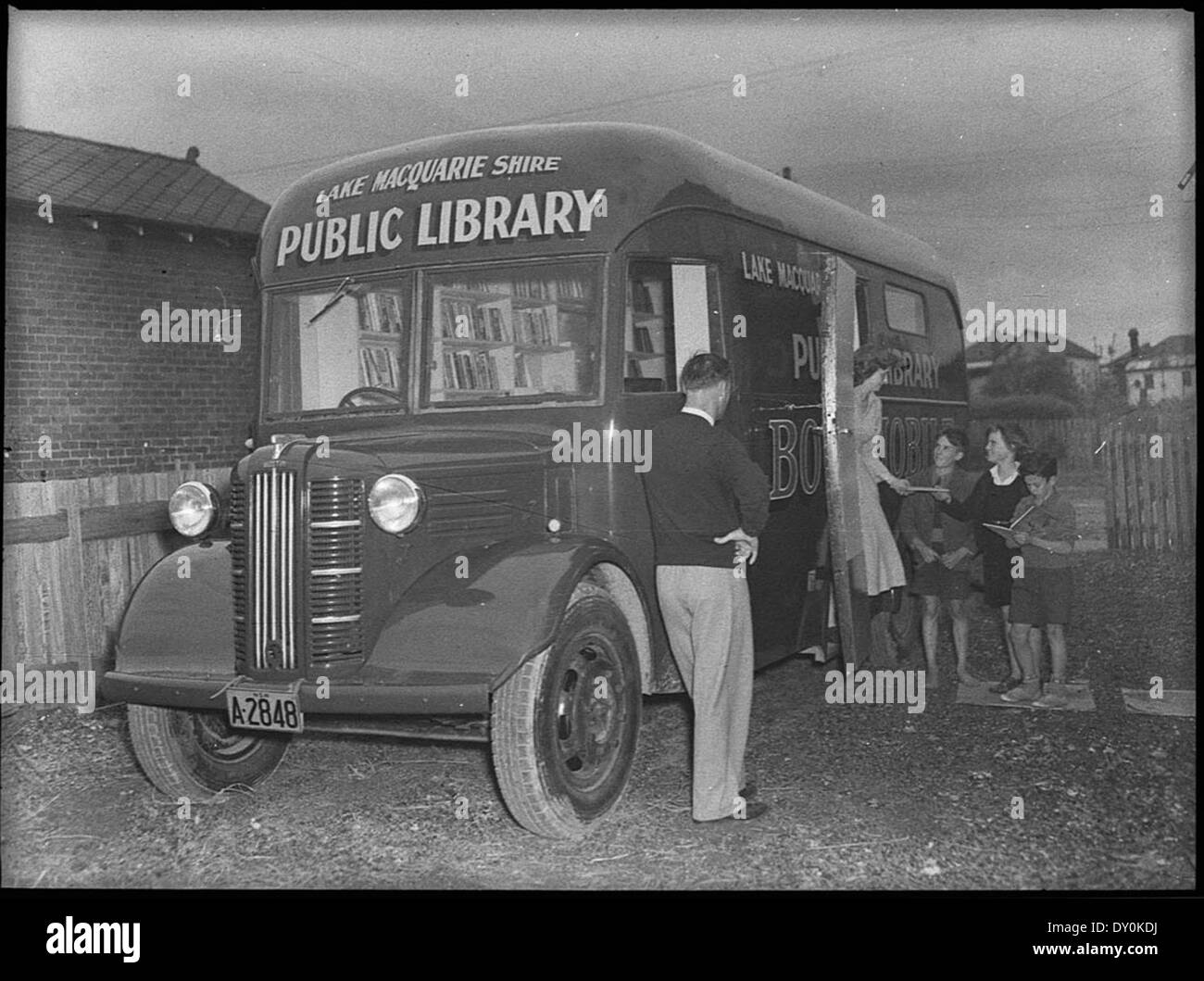 Dieses Bild, aufgenommen von Sam Hood, zeigt die mobile Bibliothek des Lake Macquarie Shire im Jahr 1950. Der Bookmobile, ein Bus, der in eine Reisebibliothek umgewandelt wurde, brachte Bücher in die Gemeinden des Shire, um das öffentliche Lesen und die Bildung zu fördern. Stockfoto