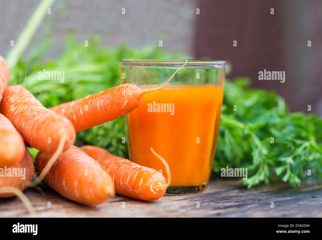 Frischer Karottensaft auf einem hölzernen Hintergrund Stockfoto