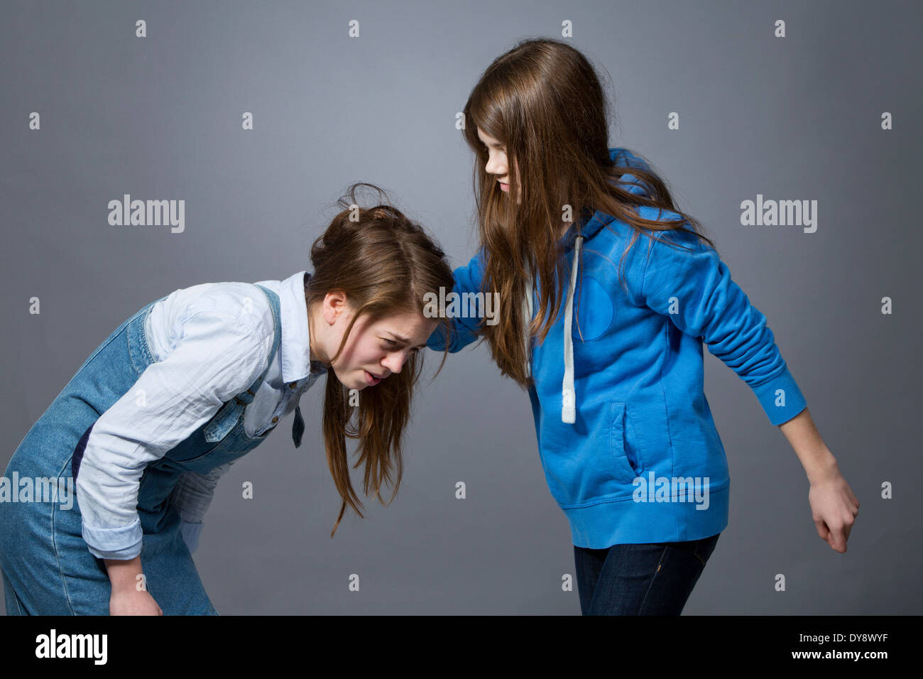 Teenager-Mädchen ziehen ihre Schwestern Haar Stockfoto
