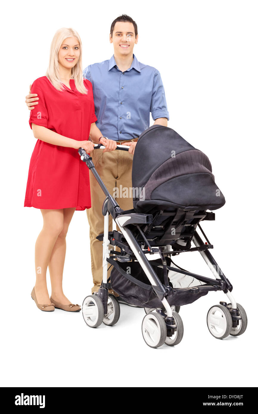 Junge Eltern mit einem Baby Kinderwagen posiert Stockfoto