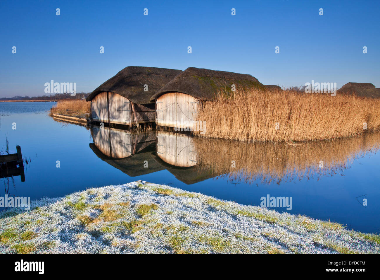 Bootshäuser am Hickling Broad an einem frostigen Wintermorgen. Stockfoto