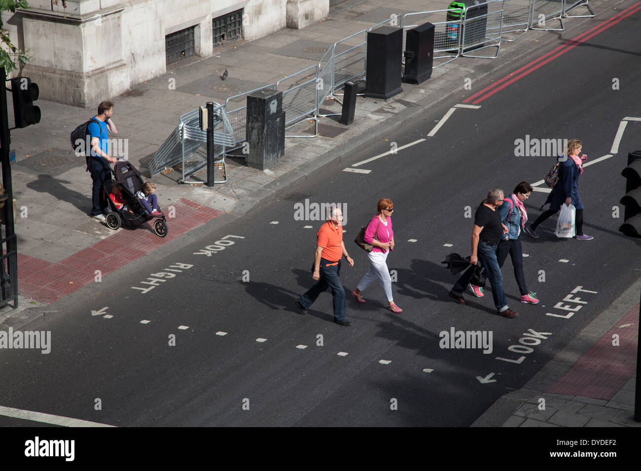 Fußgänger überqueren die Ampel gesteuert Straßenquerung. Stockfoto