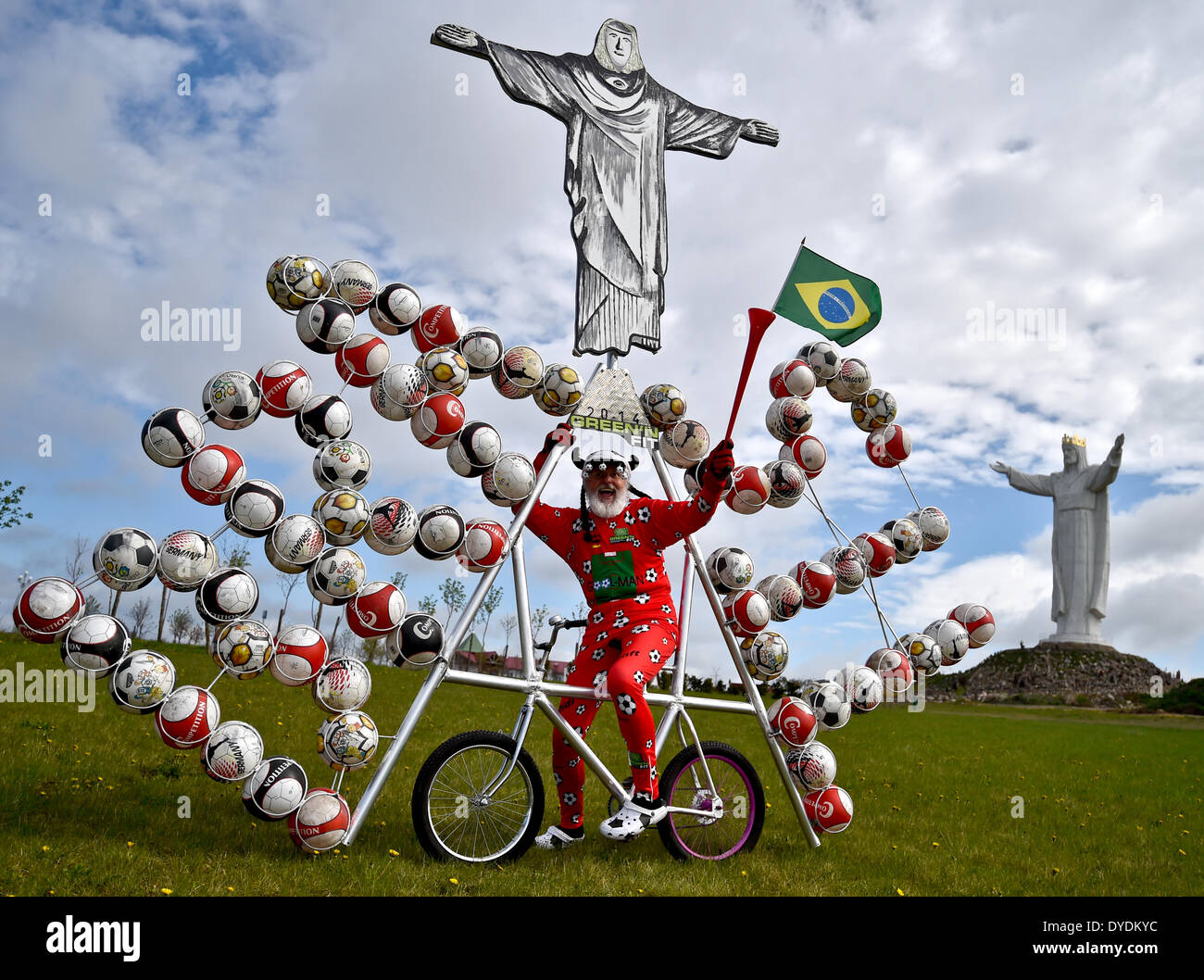 Swiebodzin, Polen. 15. April 2014. Fahrrad-Designer Dieter "Didi" Senft präsentiert seine Fußball-Fahrrad für die Fußball-Weltmeisterschaft in Brasilien in Swiebodzin, Polen, 15. April 2014. Der Designer aus Brandenburg hat ein Fahrrad mit einer Kopie der Statue Cristo Redentor in Rio De Janeiro und 72 Fußbälle entworfen. Es gibt eine Statue von Jesus in Swiebodzin sechs Meter höher als die auf Rio De Janeiro. Foto: PATRICK PLEUL/DPA/Alamy Live-Nachrichten Stockfoto