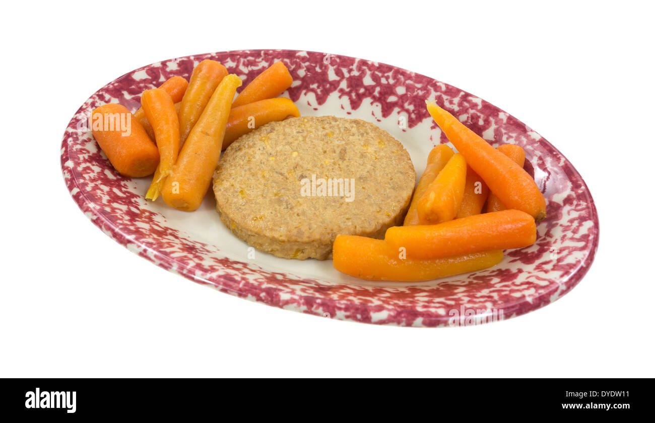 Eine pflanzliche Patty mit Karotten auf Seiten in eine ovale Schale. Stockfoto