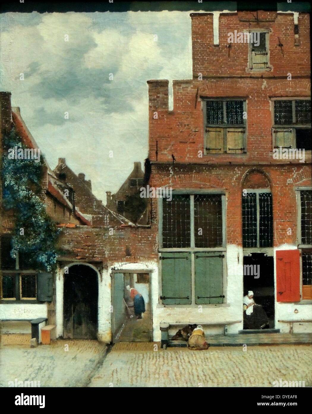 Blick auf die Häuser in Delft, wie "Die kleine Straße" von Johannes Vermeer (1632-1675), Öl auf Leinwand, c 1658 bekannt. Dieses Gemälde von einer ruhigen Straße mit ein paar Zahlen nimmt einen besonderen Platz in Vermeers Werk. Gerade Winkel geben der Komposition Gleichgewicht, während das Dreieck der Himmel eine Dynamik führt. Die alten Mauern, grobe Steine und weißen Verputz sind fast greifbar. Vermeer hat dennoch einige Freiheiten mit der Realität, wie die übergroßen grünen Fensterläden. Stockfoto