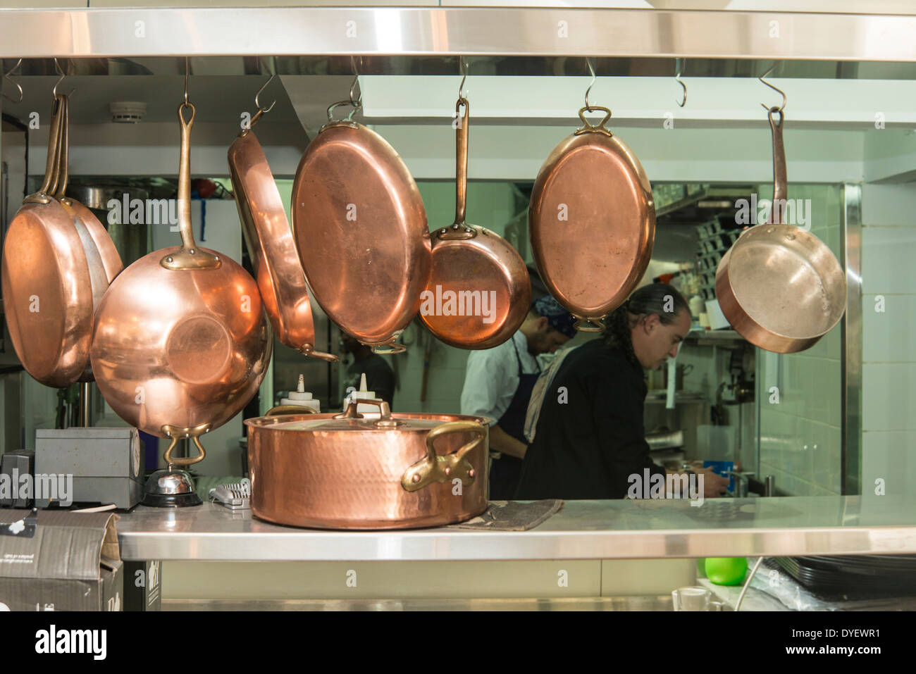 Kupferne Töpfe und Pfannen in einer Restaurantküche Stockfoto