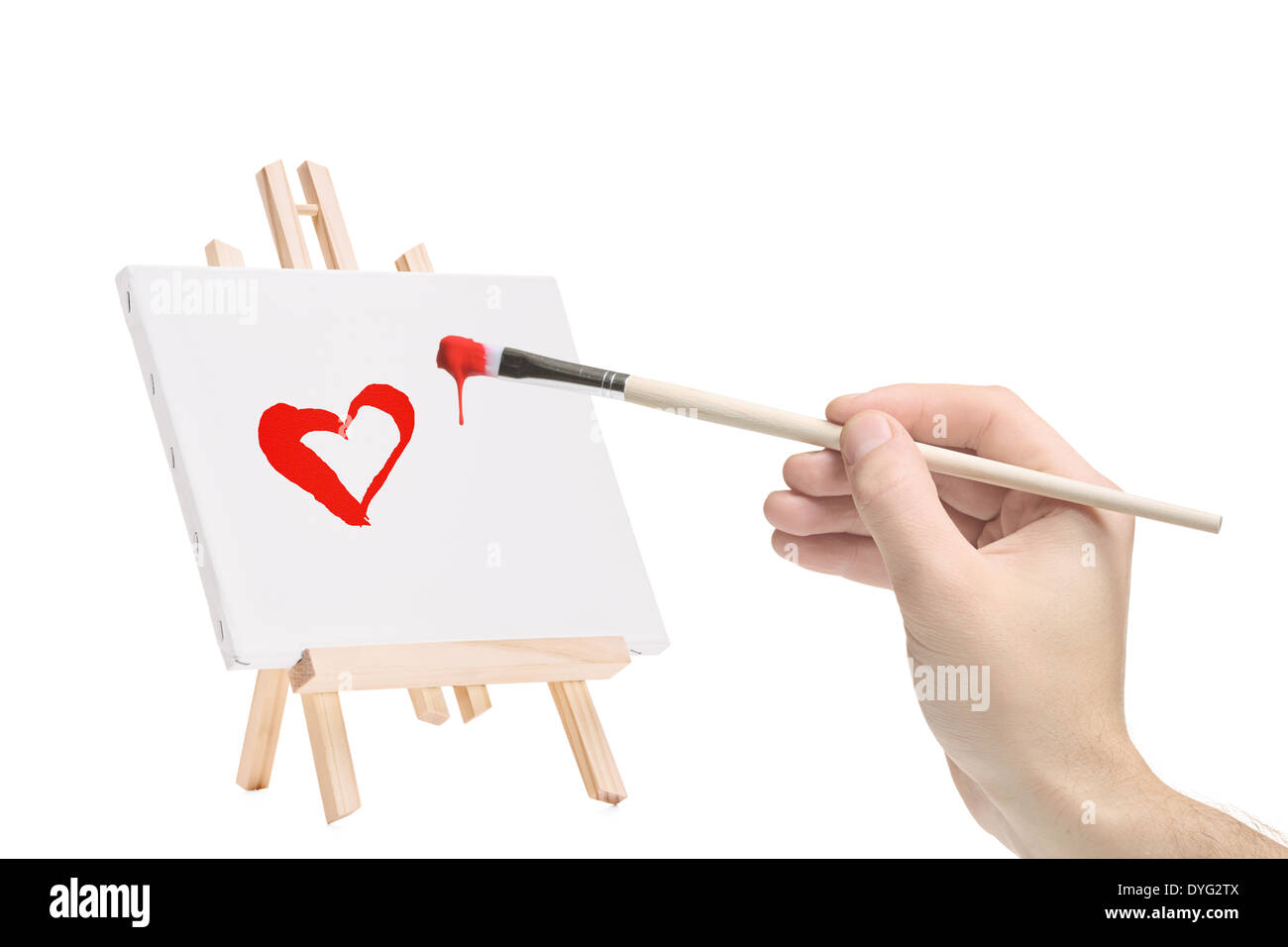 Hand mit einem Pinsel und ein Gemälde eines Herzens Stockfoto