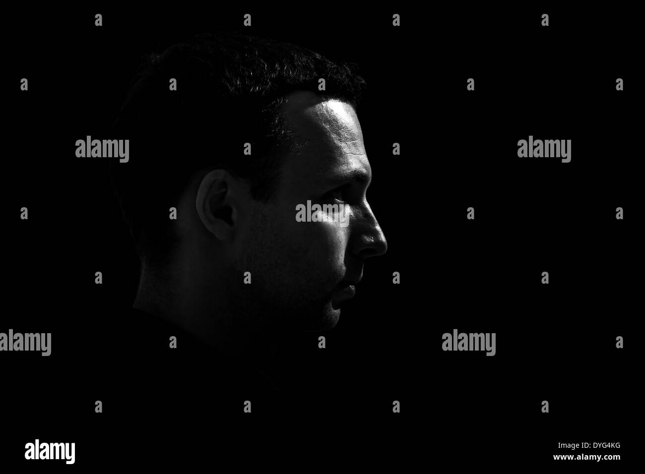 Monochrome Profilbildnis des kaukasischen Jüngling auf schwarzem Hintergrund Stockfoto