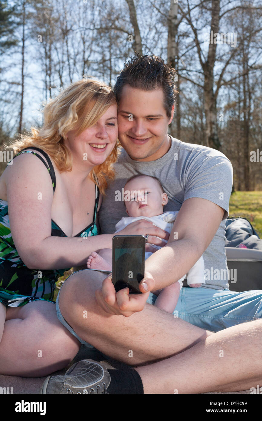 Junge Familie nimmt ein Selfie Bild mit ihrem smartphone Stockfoto