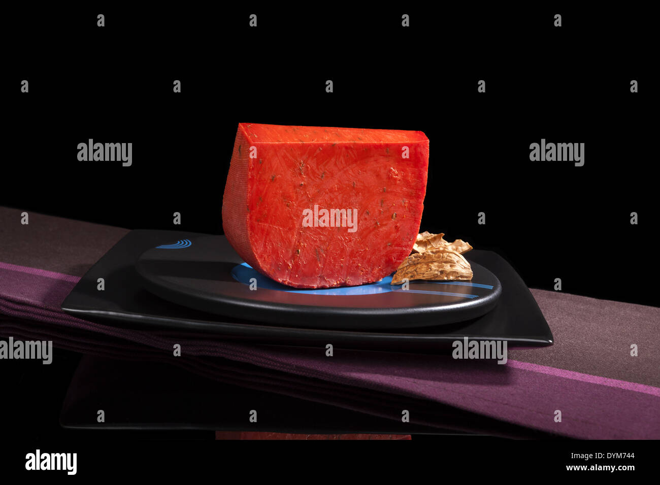 Rot-Gouda Käse-Still-Leben auf schwarzem Hintergrund isoliert. Luxuriöse Käse essen. Stockfoto