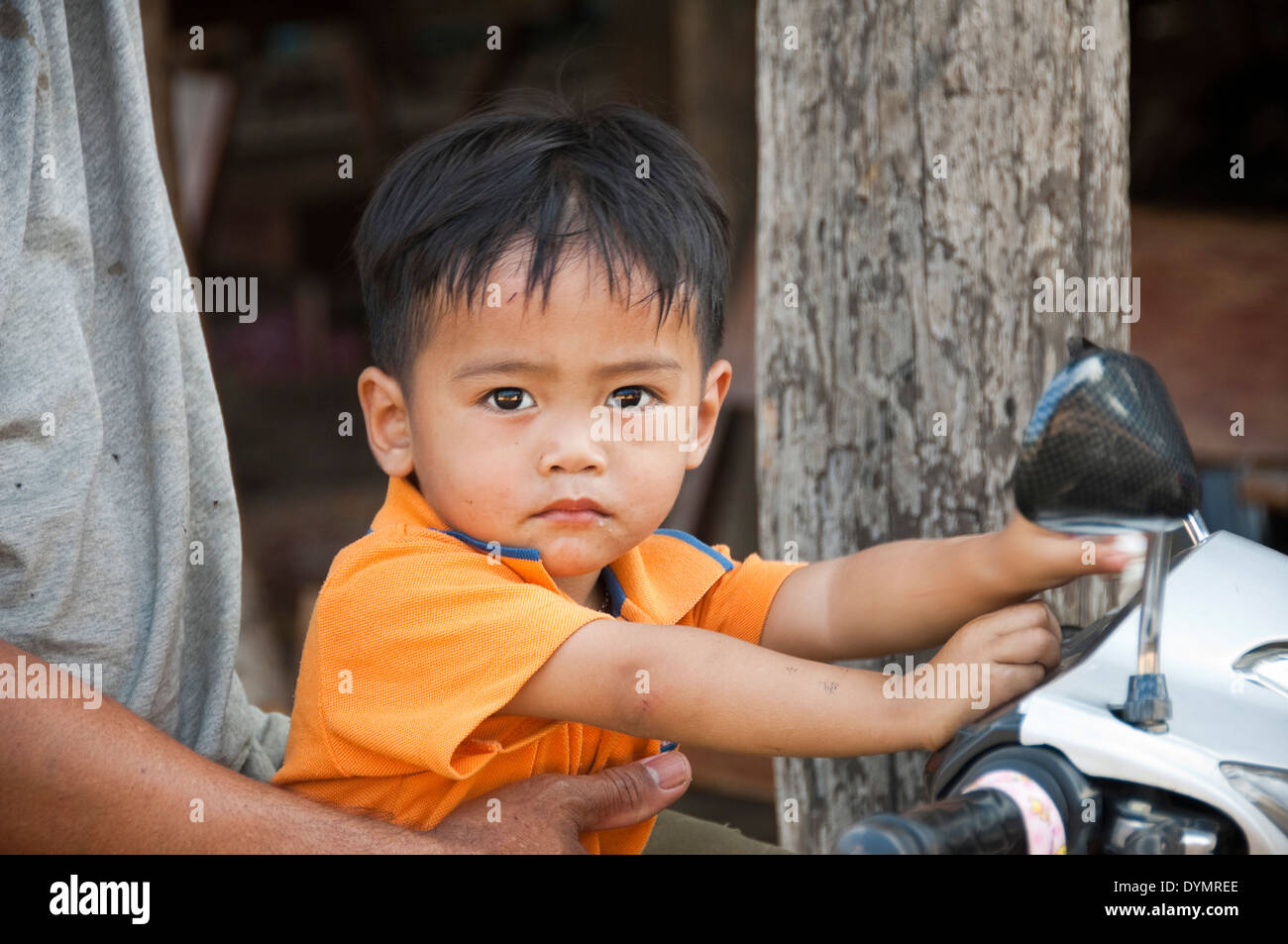 Horizontale Porträt eines attraktiven jungen auf der Vorderseite eines Motorrads in Laos. Stockfoto