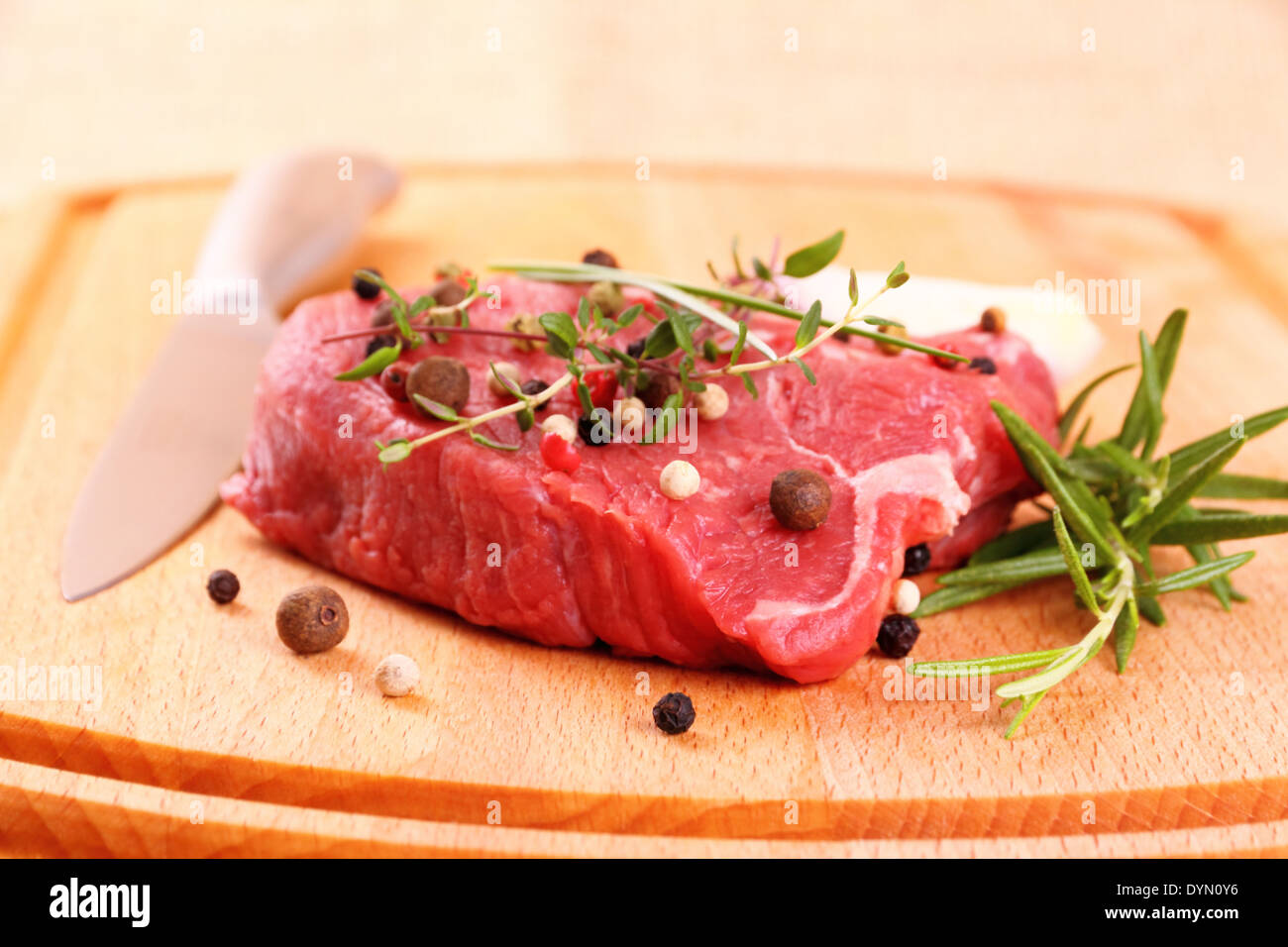 Saftiges Rindersteak mit Gewürzen, Stahl Messer, Nahaufnahme Stockfoto