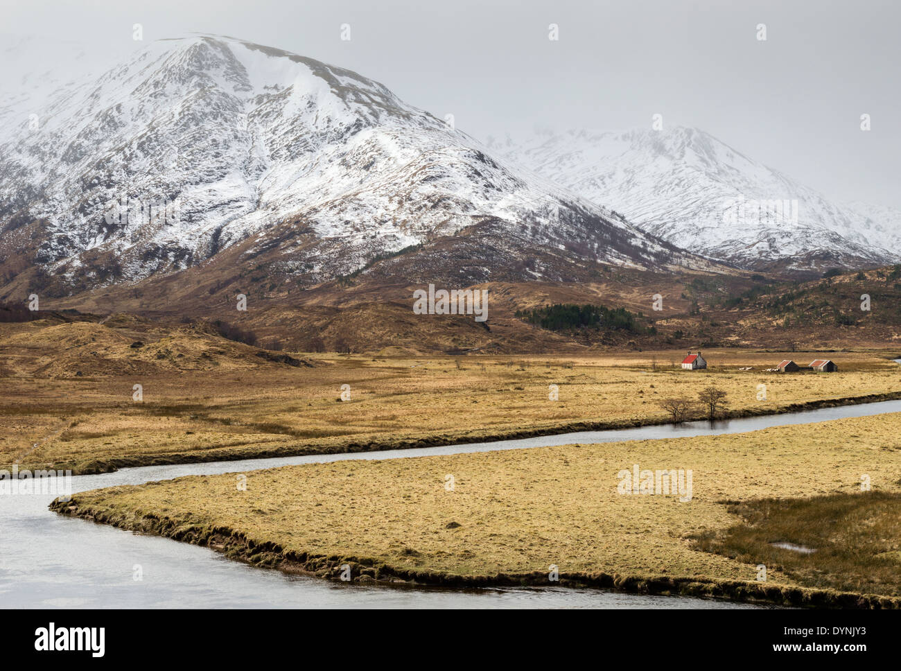 ROTES DACH DER SCHUTZHÜTTE GEGEN SCHNEE BEDECKT BERGE IN GLEN AFFRIC SCHOTTLAND IM FRÜHEN FRÜHLING Stockfoto