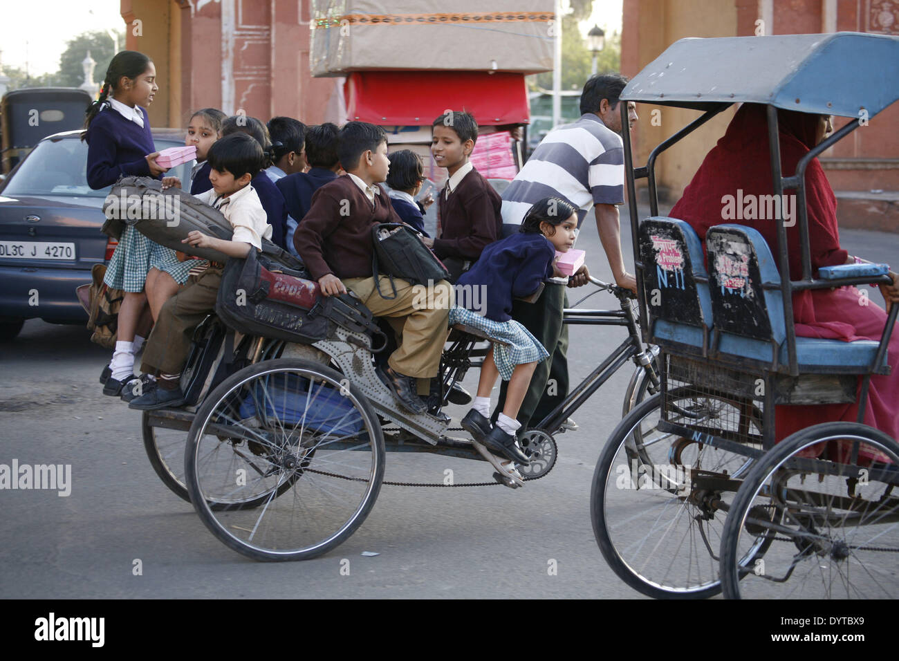 Eine Rikscha überladen mit Schulkinder laufen auf einer Straße in Jaipur Stockfoto