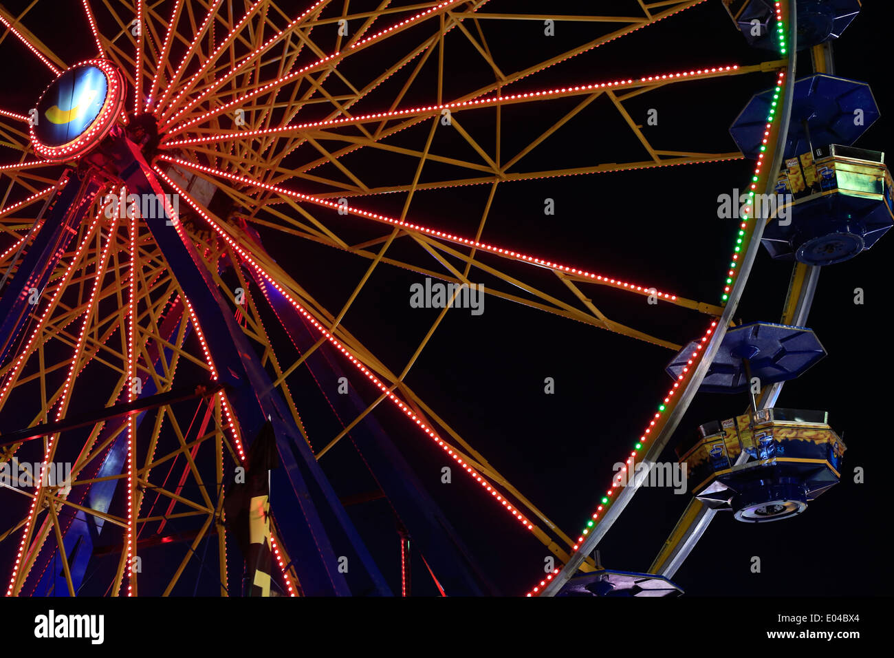 Eine Riesenrad-Fahrt leuchtet in der Nacht auf einer Messe Stockfoto