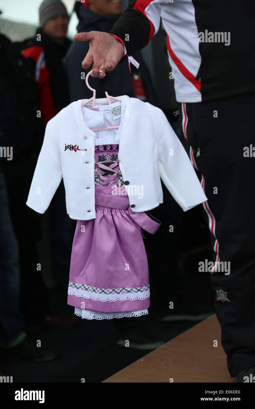 Ein lokales Mädchen Kleid "Dirndl" Geschenk, welches zu Robbie Williams während der Pressekonferenz von der 2014 Top Of The Mountain Concert am Heliport Idalpe in Ischgl, Österreich, am 3. Mai 2014. Foto: Hubert Boesl kein Draht-SERVICE Stockfoto