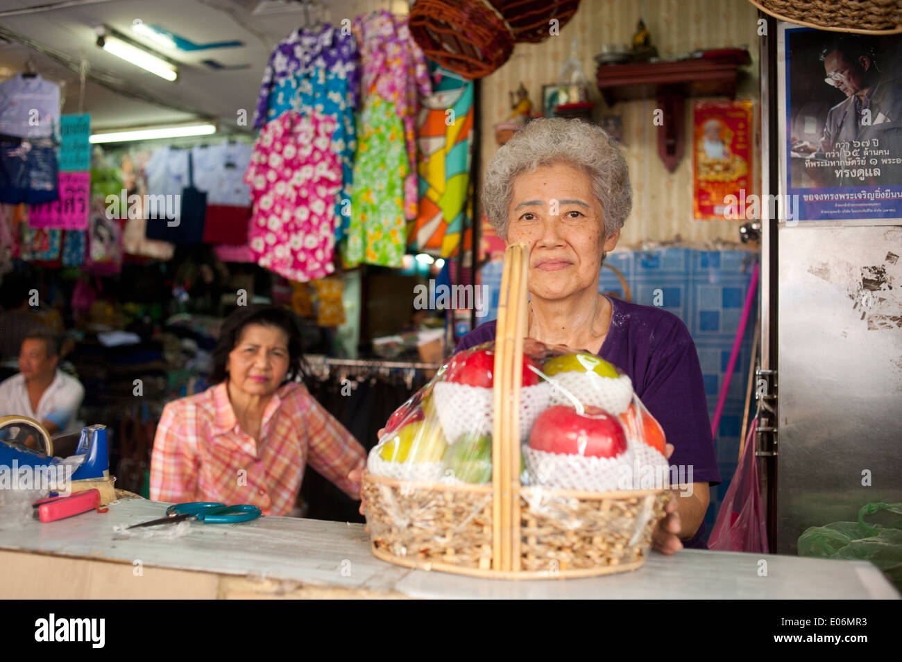 Bangkok Thailand - Seniorin Vorbereitung einen Korb mit Früchten Stockfoto