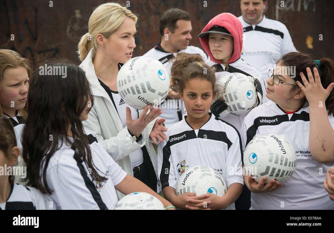 Deutsche Familienministerin Manuela Schwesig (2 L) spricht mit Kindern des SOS Kinderdorfs anlässlich des Tages der Kinder-Fußball in Berlin, Deutschland, 5. Mai 2014. Die Kinder-Fußball-Tage sind eines der größten Fußball soziale Projekte in Deutschland. Mehr als 5.000 Kinder sollen jedes Jahr an dem Projekt beteiligen. Die bundesweiten Fußball-Tage sind im Kinder Dörfer, soziale Einrichtungen und Schulen statt. Foto: HANNIBAL / Dpa/Lbn Stockfoto