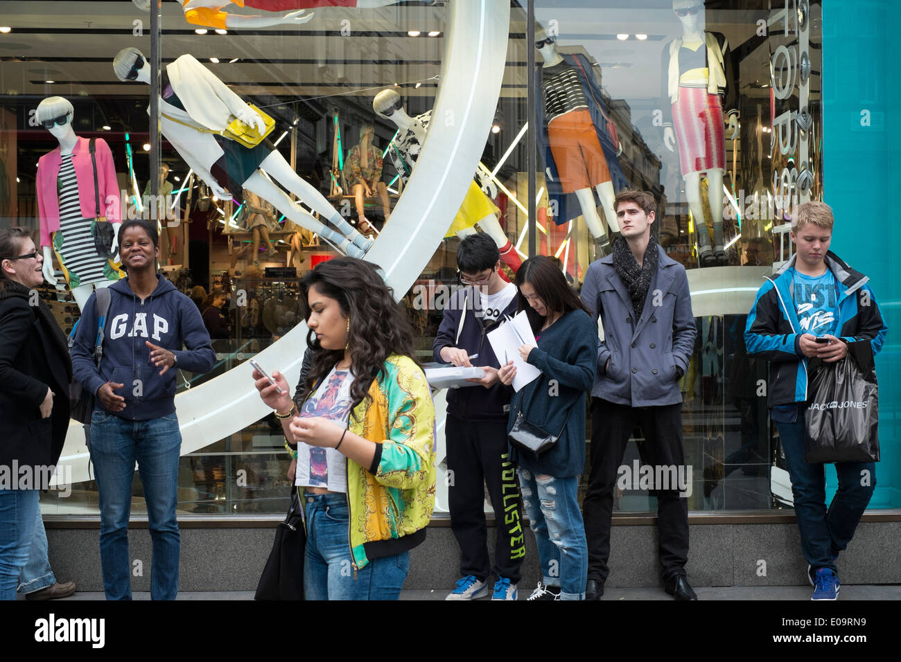 Käufer auf ihren Mobiltelefonen zu sprechen, während auf Londons Oxford Street shoppen. London. Stockfoto