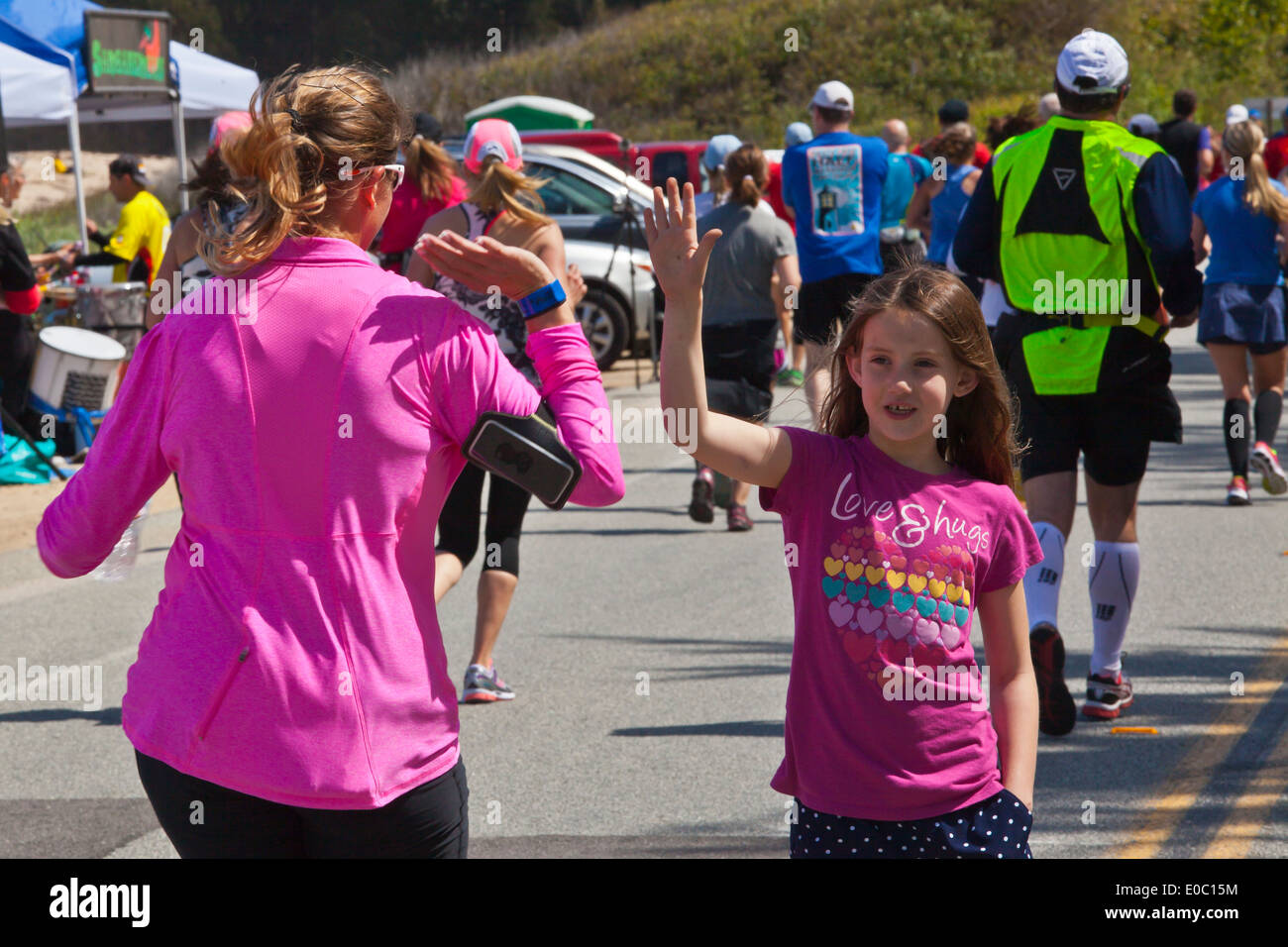 Ein junges Mädchen gibt ein high Five Läufer am Ende 2014 Big Sur Marathon - BIG SUR, Kalifornien Stockfoto
