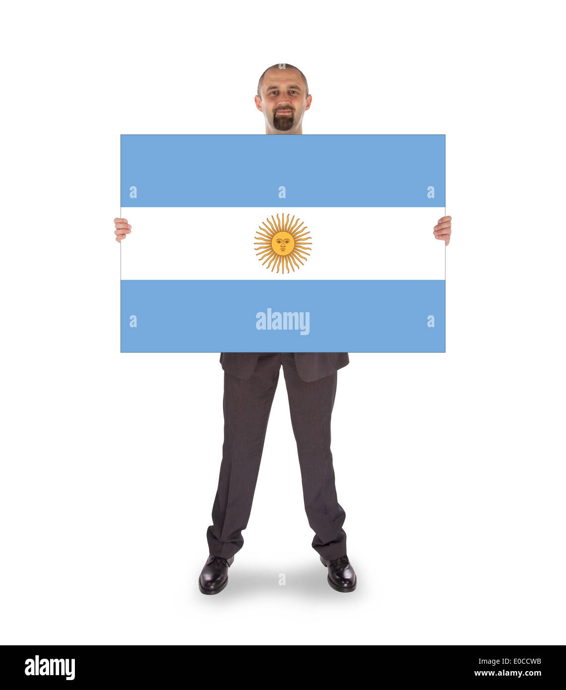 Lächelnd Geschäftsmann hält eine große Karte Fahne von argentinischen isoliert auf weiss Stockfoto