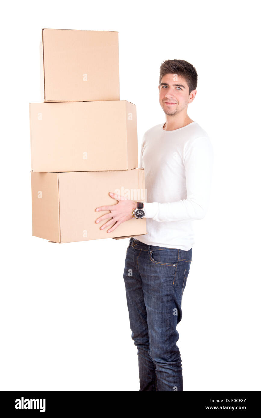 Hübscher junger Mann mit Kartons Auspacken im neuen Zuhause Stockfoto