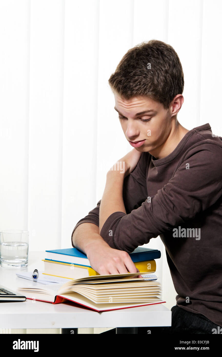 Ein junger Student lernen mit Büchern, Ein Junger Schüler Beim Lernen Mit Baeuechern Stockfoto