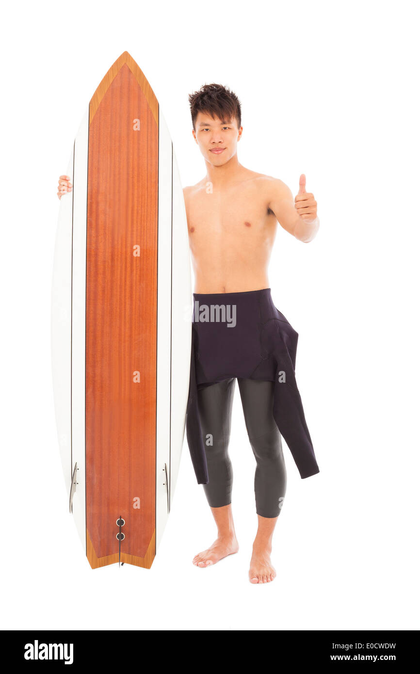 junge Surfer tragen Neoprenanzug und Daumen oben Stockfoto