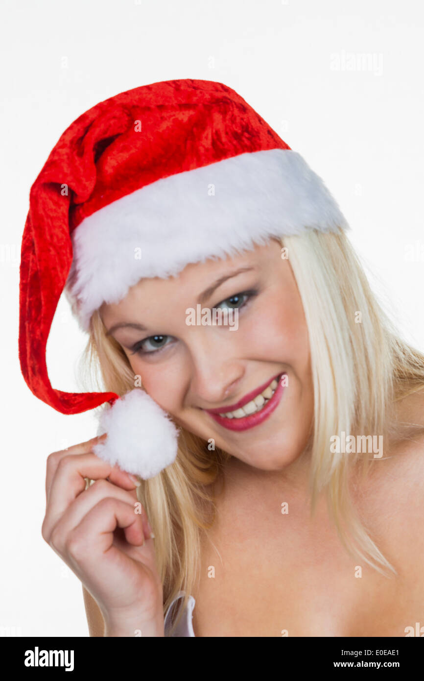 Eine junge Frau mit der Mütze Weihnachtsmann. Weihnachten-Frau zu Weihnachten vor weißem Hintergrund., Eine Junge Frau Mit der Muet Stockfoto