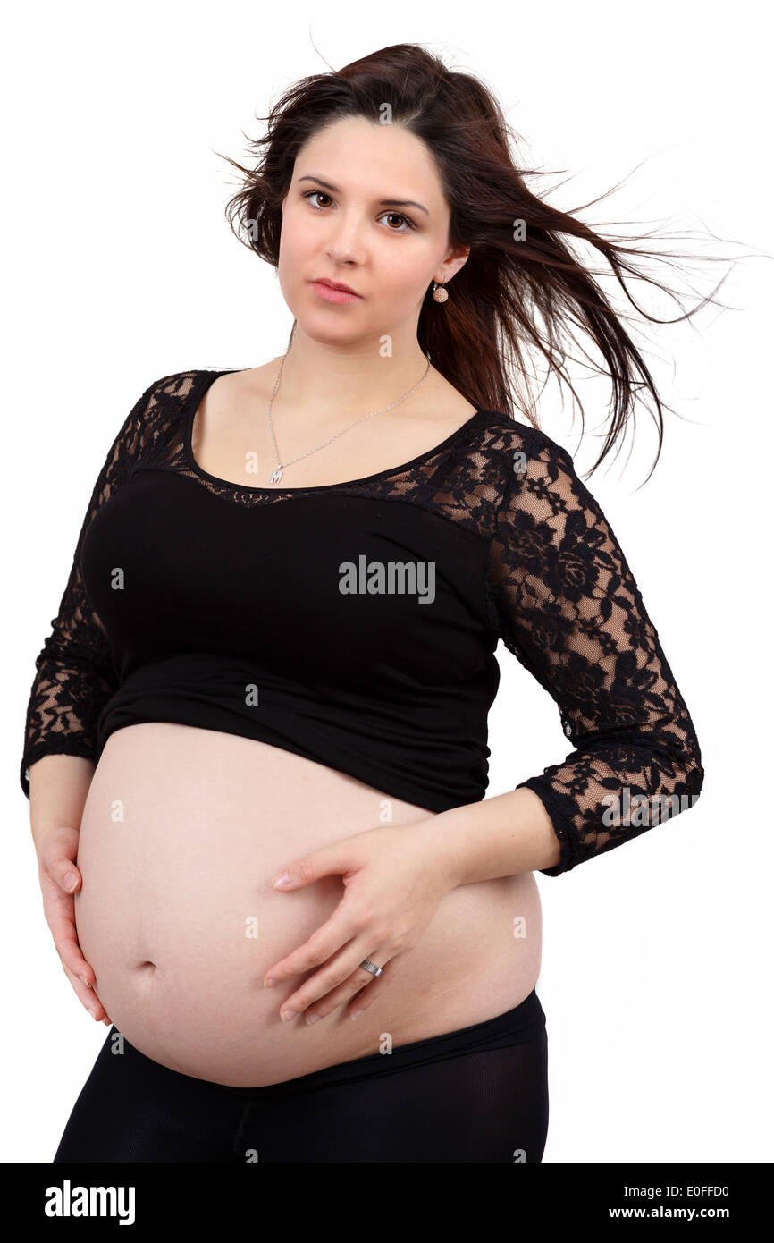 schönes Lächeln schwanger Frau zärtlich mit ihrem Bauch isoliert auf weißem Hintergrund Stockfoto