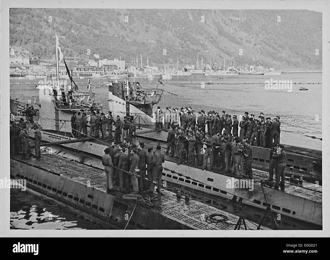 Ein Kriegsbild aus dem Zweiten Weltkrieg, das U-Boote zeigt, die an einen deutschen Hafen andocken, und zeigt die fortgesetzten militärischen Operationen während des Zweiten Weltkriegs. Das Bild enthält auch Hinweise auf die Besetzung Norwegens und die Rolle der Streitkräfte. Stockfoto