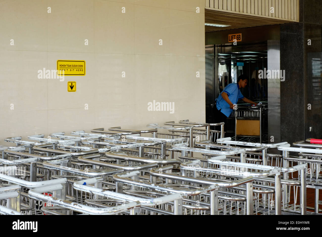 Mitarbeiter laden Gepäckwagen in einen Aufzug am internationalen Flughafen Soekarno-Hatta Jakarta Indonesien Stockfoto