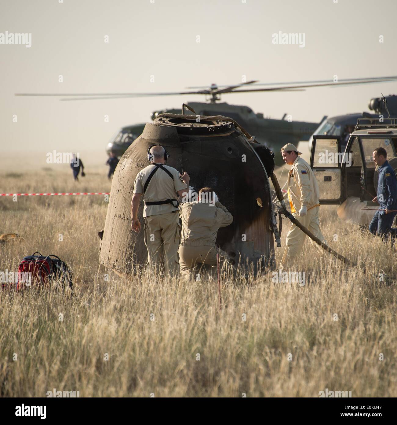 Support-Mitarbeiter bereiten die Crew aus dem Raumschiff Sojus TMA - 11M zu fordern, kurz nachdem es tragenden Besatzungsmitglieder der ISS-Expedition 39 14. Mai 2014 in der Nähe der Stadt Zhezkazgan, Kasachstan gelandet. Wakata, Tyurin und Mastracchio Rückkehr zur Erde nach mehr als sechs Monate an Bord der internationalen Raumstation ISS, wo sie als Mitglieder der Expedition 38 und 39 Mannschaften dienten. Stockfoto