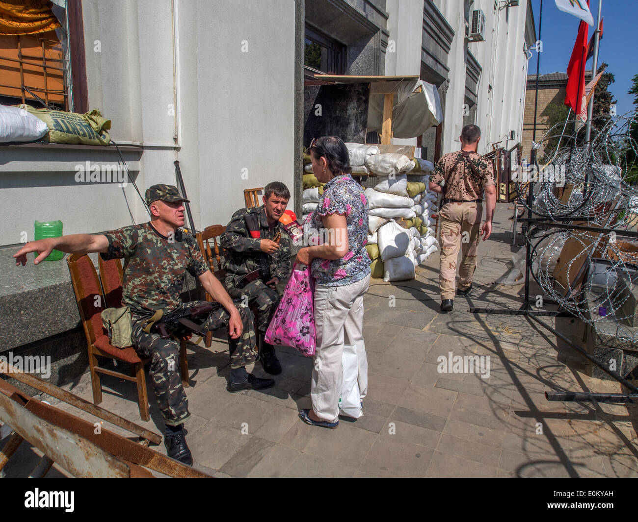 Luhansk, Ukraine. 16. Mai 2014. Bewaffnete Separatisten bewachen sie Lugansk Regionalverwaltung gefangengenommen bieten Mitarbeiter des Justizministeriums auf einem anderen Weg, um ihren Job zu übergeben. ---Nach der Ankündigung der Führer der selbst-Protslaimed weiterhin Lugansk Volksrepublik den Sieg bei dem Referendum die Stadt in der Schwebe zu leben. Verschlechterung der Lebensmittelversorgung, Läden geschlossen. Bildnachweis: Igor Golovnov/Alamy Live-Nachrichten Stockfoto