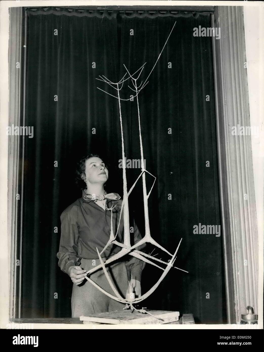01. Januar 1955 - Vorbereitung Der Kunstausstellung "Junge Zeitgenossen". Arbeit der amerikanischen Ethnie. Foto zeigt Carrol Simms eine amerikanische Ethnie - ist der Schöpfer dieses Werkes namens ''Spring'' (Eine Brunnenstudie), das von Miss Pamela Butler vom Holland Park bewundert wird - im R.B.A. Galerien, Suffolk Street - heute Morgen während der Vorbereitungen für die „'Young Zeitgenossen'' Kunstausstellung, die morgen eröffnet wird. Carrol Simms studiert an der Slade School of Art - nachdem er ein Stipendium in den Vereinigten Staaten gewonnen hat. Stockfoto