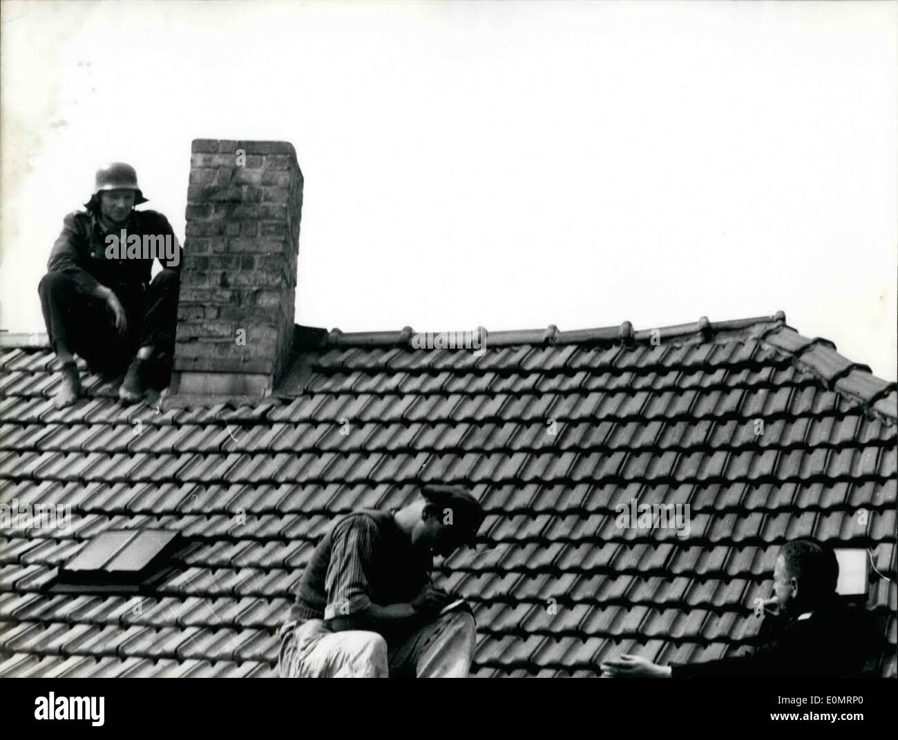 8. August 1956 - Kampf für die Freiheit auf einem Dach... ist ein junger Göttingen-Arbeiter, die in einer Irrenanstalt als schwerer Kranke kriminelle stattfand. Er floh es und "Jude gefunden un ein Dach Polizisten sagte er, dass er nach unten entstehen würde und Selbstmord, wenn er in die Anstalt zurückgebracht werden sollten. Nachdem er nicht gesagt bekam sein senden zurück He follo4ed der begleitenden Ftreguardman auf dem Dach. Stockfoto