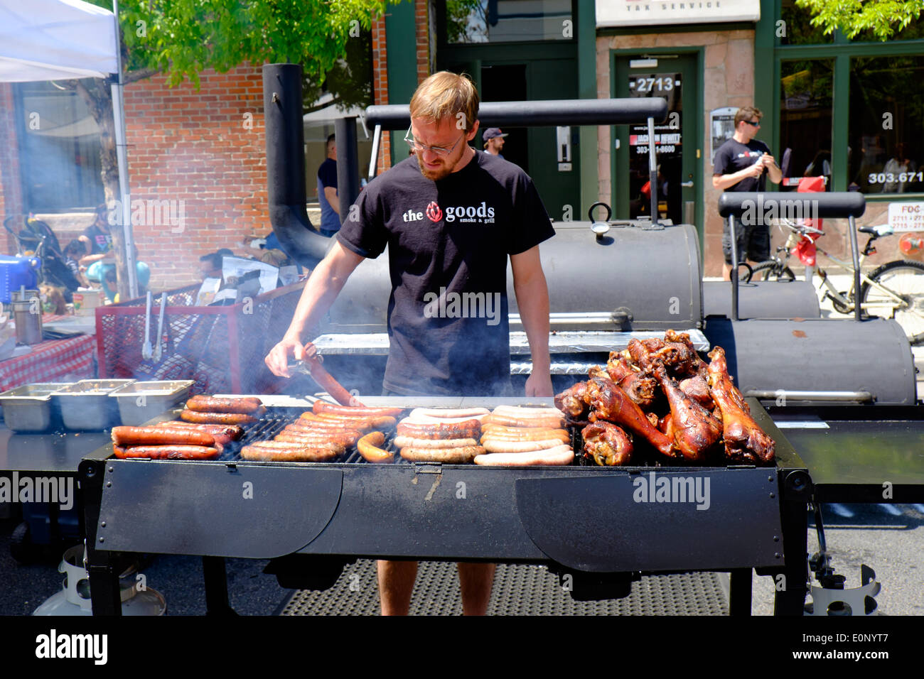 Denver Colorado USA – 17. Mai 2014 Grill Kochen von The Smoke waren und Grill-Restaurant bereitet Würstchen und Türkei Beine auf dem 17. fünf Punkte Jazz Festival.  Das Festival feiert die Geschichte von Denvers fünf Punkte Nachbarschaft bekannt einmal als die Harlem des Westens. Fünf Punkte war Heimat von mehreren Jazz clubs welche spielte Gastgeber für viele der jazz-Musik-Legenden wie Miles Davis, Thelonious Monk und vieles mehr. Bildnachweis: Ed Endicott/Alamy Live-Nachrichten Stockfoto