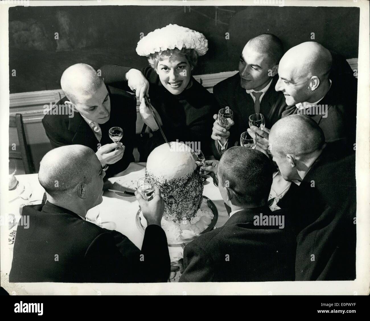 8. März 1957 - sechs Glatzen - und A Cake To Match - Birthday Party In London: The Rex Whistler Room in der Take-Galerie war Schauplatz einer Besinnung Zeremonie gestern - wenn Agnes Berovello ihr 28. gefeiert. Geburtstag - mit einer Party. Sie war Gast bei der '' sechs Söhne auf Scimitar'', die alles kahl - sind und natürlich die Geburtstagstorte hatte sich als "kahl" '' sechs Söhne ''- und Agnes erscheinen in '' die Wunder-volle Lampe '' - im London Palladium. Foto zeigt Agnes Berovello - schneidet den kahlen Kuchen - eine der sechs Balder Sperre auf. Stockfoto
