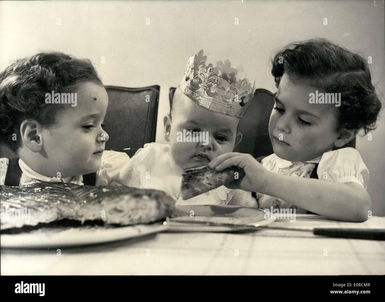 4. Januar 1959 - bereit für Epiphany: 1-Year-Old Michael Seems zu bewundern die traditionellen Apiphany Kuchen serviert durch seine kleinen Schwestern während ein kleinen Bruder schaut. Stockfoto