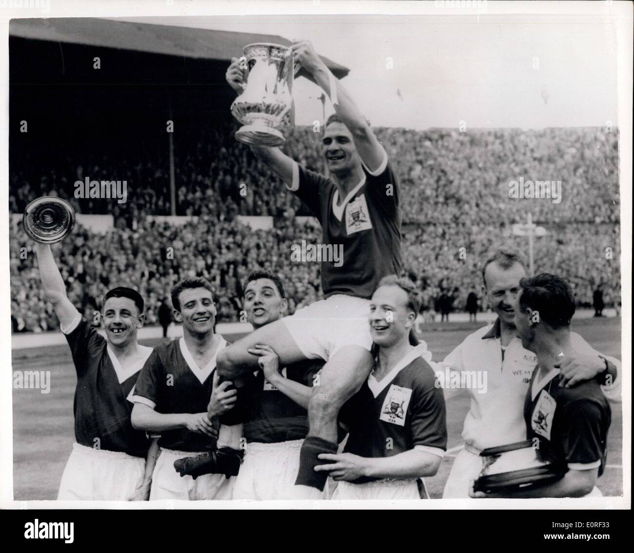 2. Mai 1959 - Notts Wald gewinnen The FA Cup mit zehn Männer: Nottingham Forest Wion TheFootball Association Cup mit einem 2: 1-Sieg gegen Luton Town im Finale im Wembley-Stadion heute, trotz des Verlustes von Rechtsaußen Roy Dwight, wer seinen rechten Schienbein brach nach 35 Minuten spielen. Foto zeigt Jock Burkitt, der Kapitän der Nottes Wald, erfolgt shoulder hoch von seinen Teamkollegen, nachdem sie mit dem FA-Cup von H.M Königin vorgestellt wurde nachdem sie geschlagen Luton Town durch zwei Tore t man in der Cup-Finale im Wembley-Stadion heute gehabt. Stockfoto