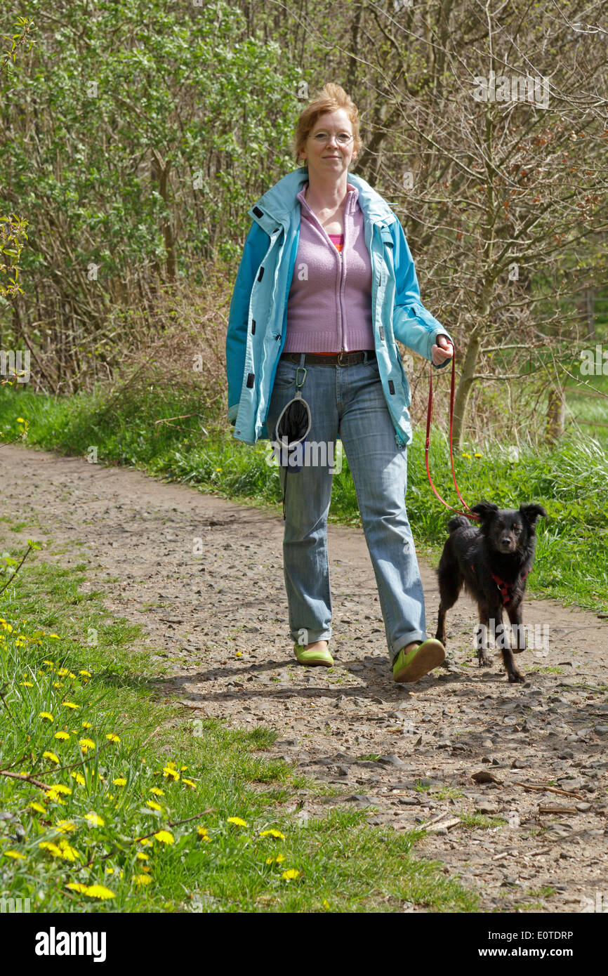 Frau, die ihren Hund Stockfoto