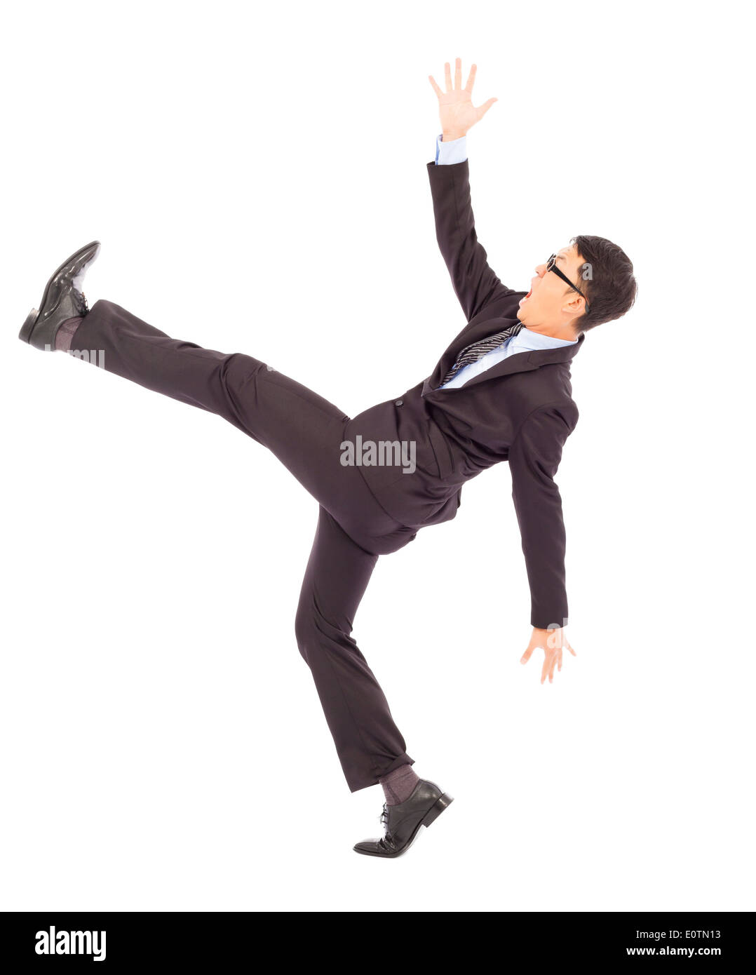 Geschäftsmann Rutschen und fallen und eine lustige pose Stockfoto